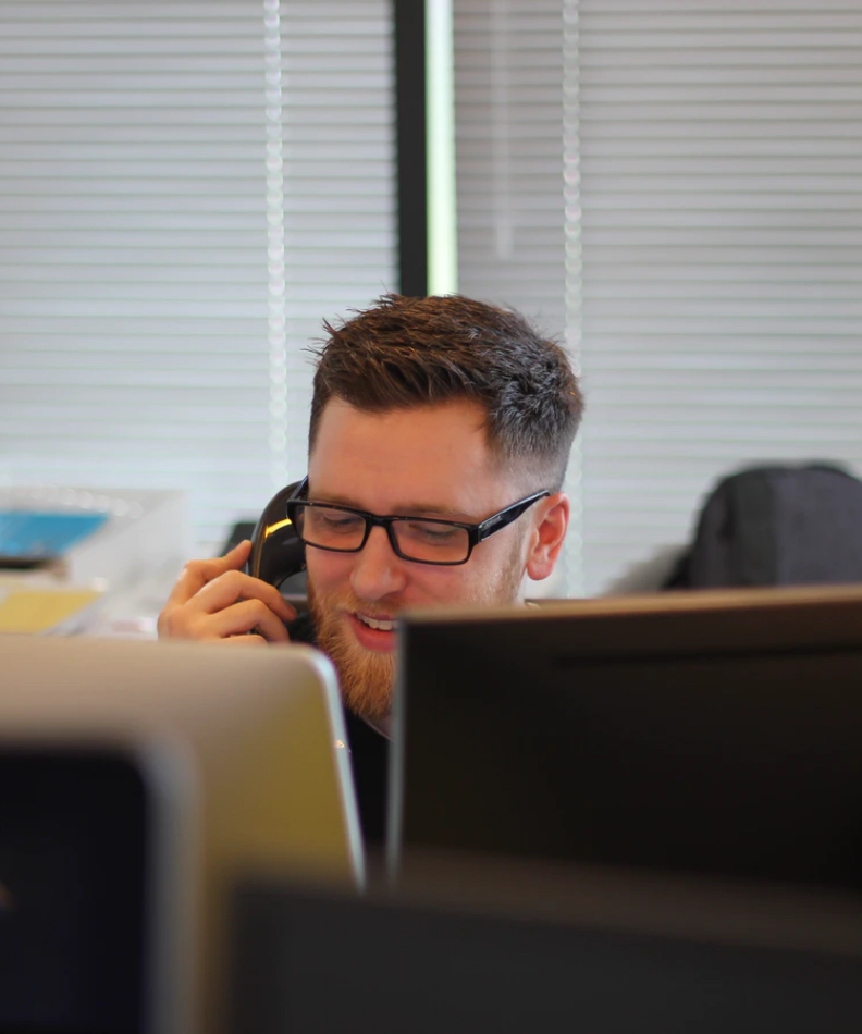 Photo of a man speaking on a phone.