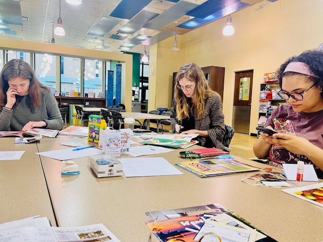 Students engage in a study session at a table with books and papers, part of Wright State University's library maker series.