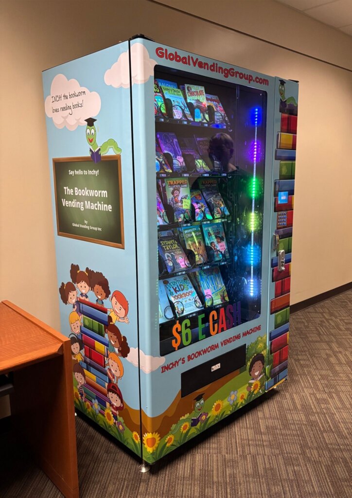 Image of The Bookworm Vending Machine at Eastern Local Schools. Children's books are neatly displayed in a colorful vending machine for students to purchase using the school's E-Cash system.