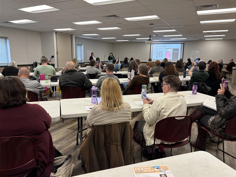 attendees listening to Boom and Bust presentation